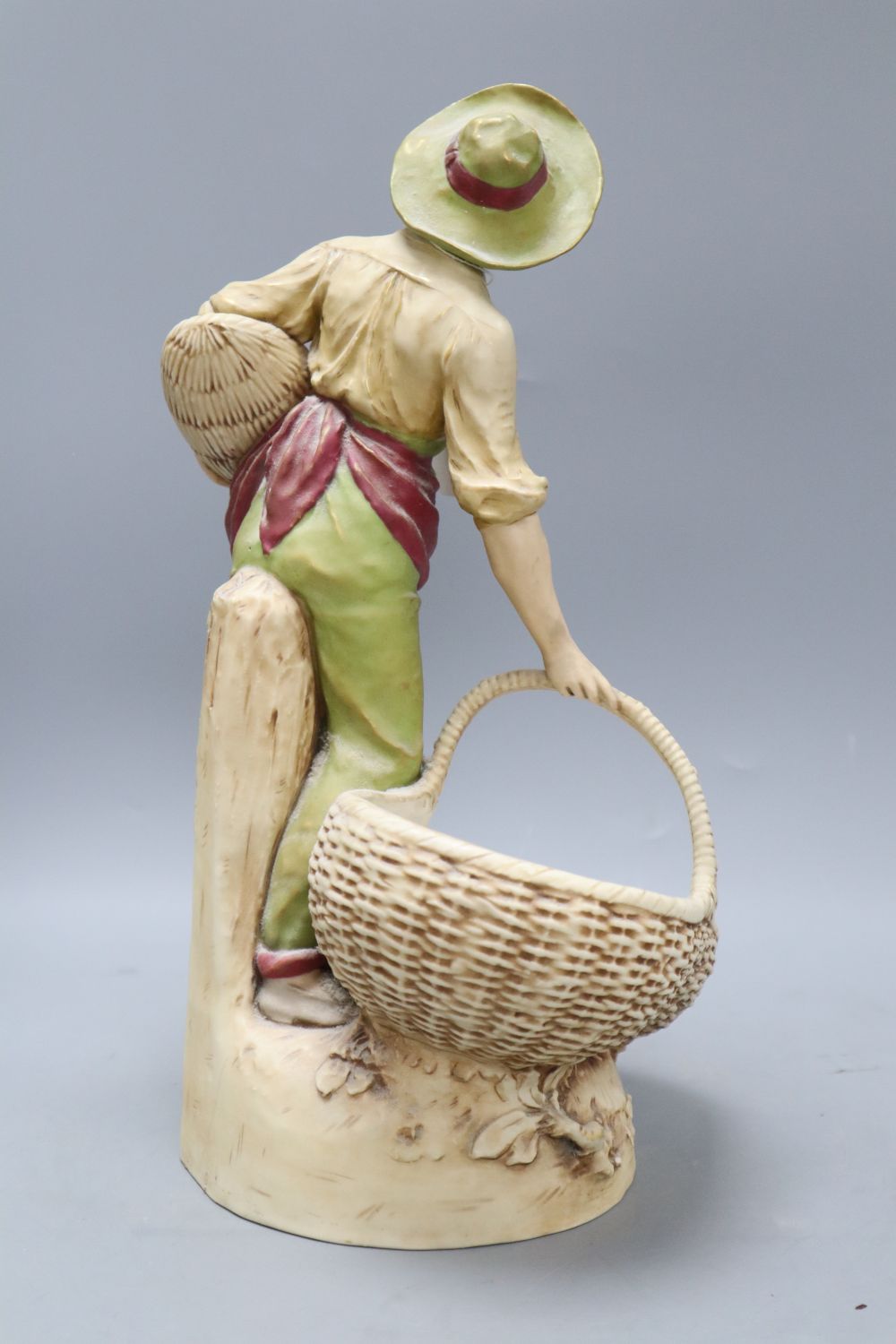 A Royal Dux figure of a boy carrying baskets, height 40cm